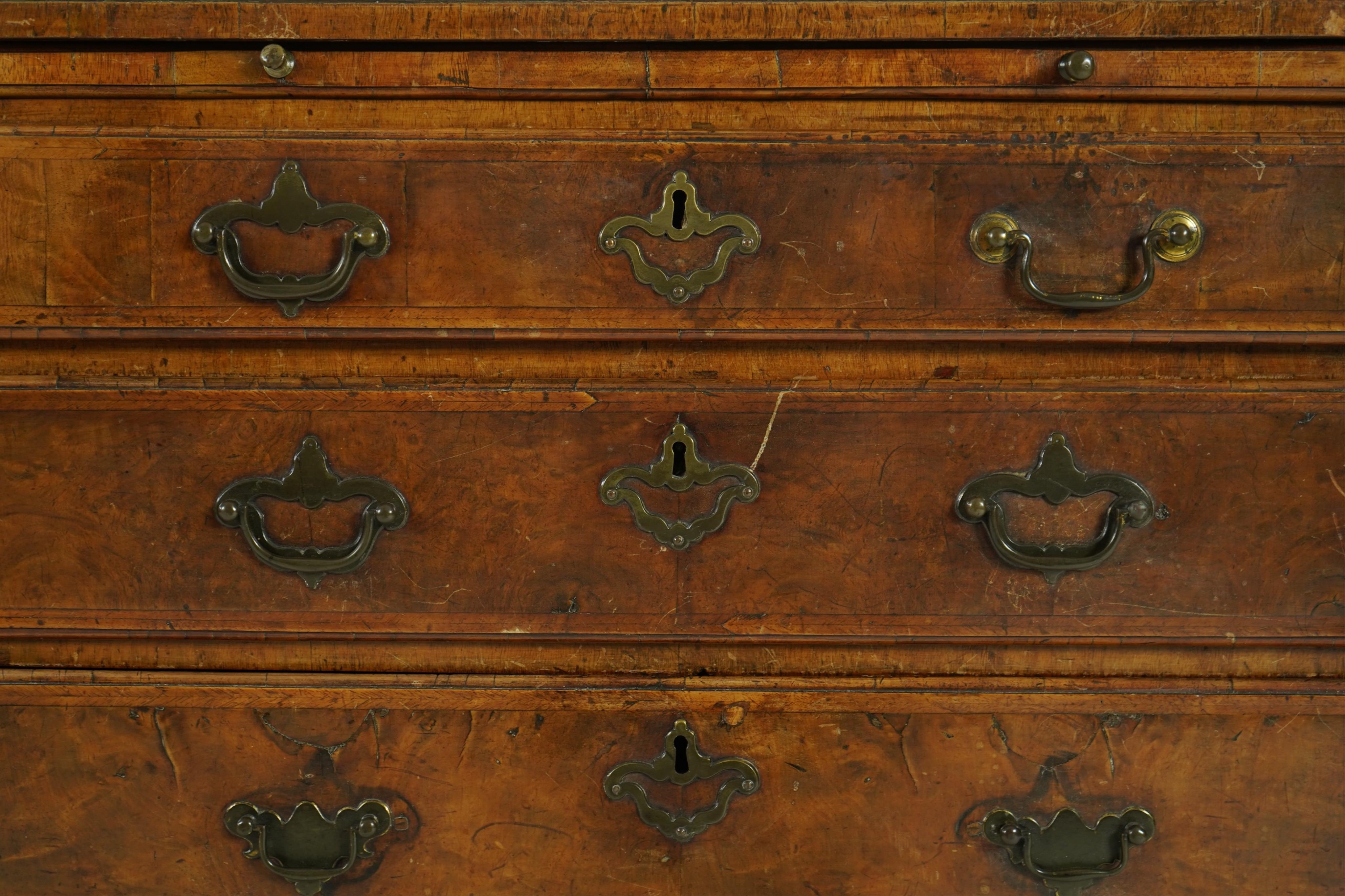 A small early 18th century and later cross and feather banded walnut veneered chest